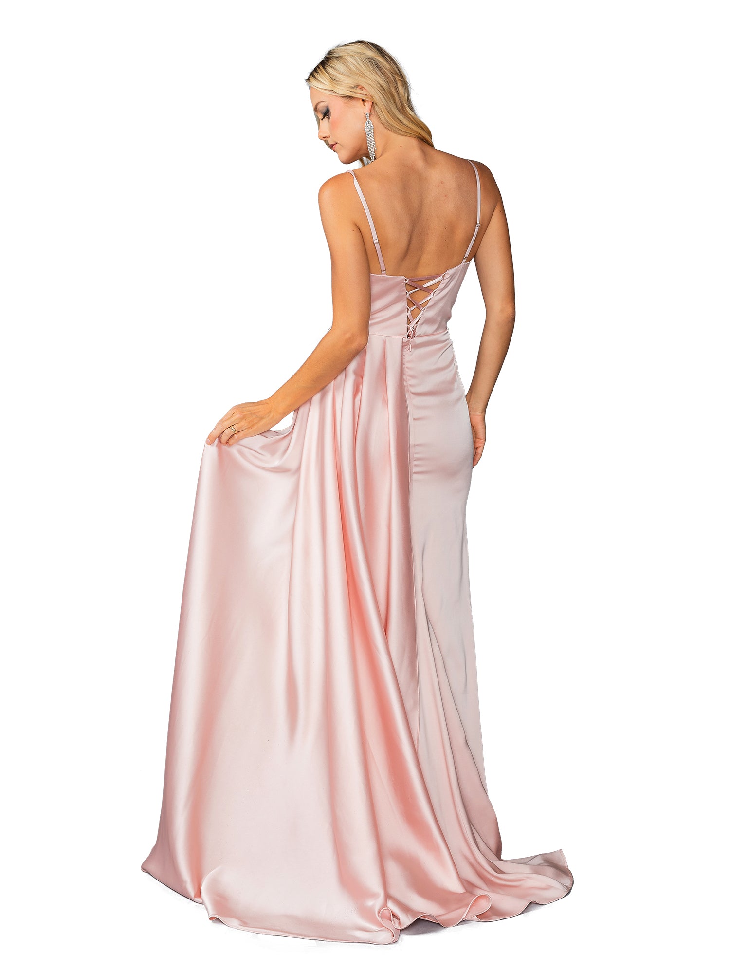 A woman in the Beaded-Bust Long Prom Dress Dancing Queen 4412 with a sweetheart neckline and lace-up back stands facing away, holding the skirt to the side against a white background.